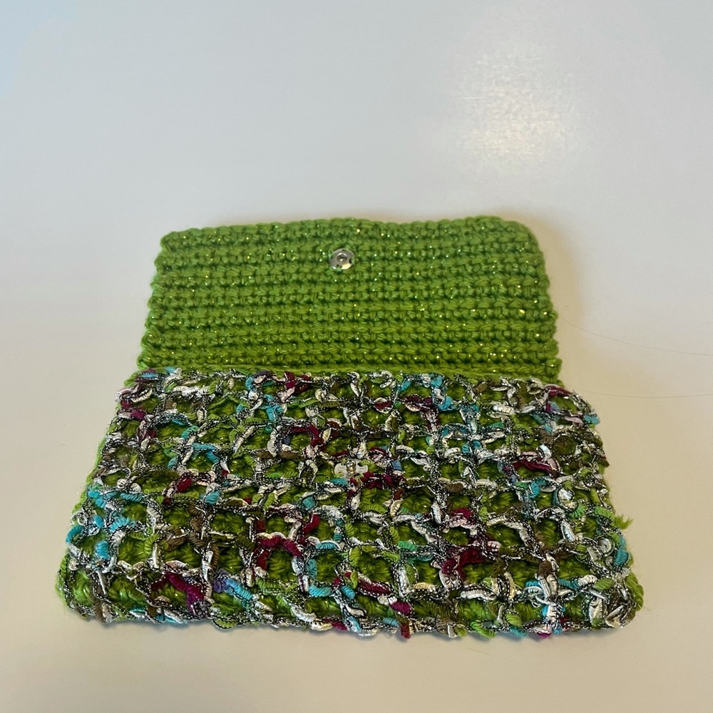 Green knit clutch bag with single rhinestone button closure. Handmade crocheted